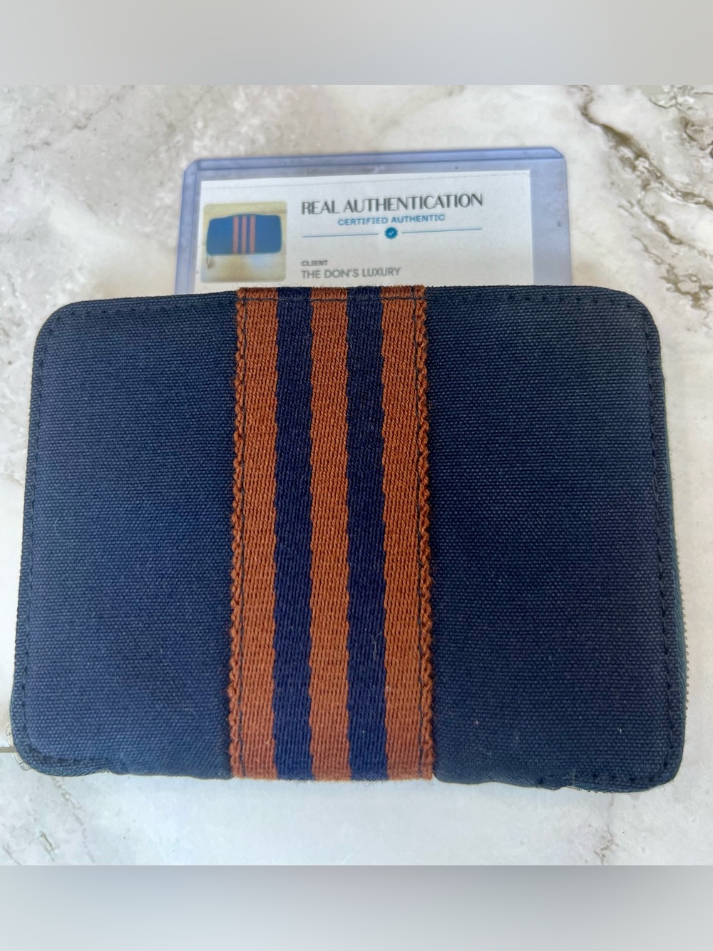 Hermès Fourre Tout canvas wallets in navy blue with brown stripes. GUC with COA